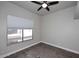 Bedroom features a window, neutral walls, wood floors, and a ceiling fan at 8180 E Shea Blvd # 1075, Scottsdale, AZ 85260