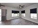 Bedroom featuring hard wood floors, three windows, and a ceiling fan at 8180 E Shea Blvd # 1075, Scottsdale, AZ 85260