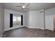 Spacious bedroom features wood floors, a ceiling fan, and a large window at 8180 E Shea Blvd # 1075, Scottsdale, AZ 85260
