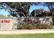 Stone sign welcomes you to The Vintage, enhanced with red flowers and lush landscaping at 8180 E Shea Blvd # 1075, Scottsdale, AZ 85260