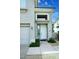 Inviting front entrance with a white door and a well-manicured landscape leading to a two car garage at 8180 E Shea Blvd # 1075, Scottsdale, AZ 85260