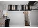 Organized garage space featuring upper cabinets, water heater, and convenient access door at 8180 E Shea Blvd # 1075, Scottsdale, AZ 85260