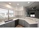 Bright kitchen features white countertops, gray cabinets, stainless steel appliances, and mosaic tile backsplash at 8180 E Shea Blvd # 1075, Scottsdale, AZ 85260