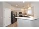 A well-lit kitchen with stainless steel appliances, gray lower cabinets, and a white bar height countertop at 8180 E Shea Blvd # 1075, Scottsdale, AZ 85260