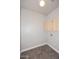 Bright laundry room with wood-look vinyl flooring and ample storage cabinets at 8180 E Shea Blvd # 1075, Scottsdale, AZ 85260