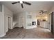 Expansive living area featuring gray flooring, modern ceiling fans, and a clear view into the well-lit kitchen at 8180 E Shea Blvd # 1075, Scottsdale, AZ 85260