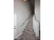 An interior shot of an empty staircase with natural wood planks and gray walls at 8180 E Shea Blvd # 1075, Scottsdale, AZ 85260