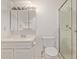 White bathroom features a glass door shower, toilet and vanity sink at 8328 E Chaparral Rd, Scottsdale, AZ 85250