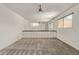 Bright bedroom features a ceiling fan, a mirrored wall and a carpeted floor at 8328 E Chaparral Rd, Scottsdale, AZ 85250