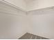Walk-in closet featuring an empty shelf and a carpeted floor at 8328 E Chaparral Rd, Scottsdale, AZ 85250