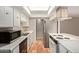 Bright kitchen with white cabinets, stainless steel appliances, tiled floors and a skylight at 8328 E Chaparral Rd, Scottsdale, AZ 85250