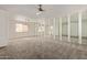 Spacious living room featuring mirrored wall, neutral carpet, and abundant natural light at 8328 E Chaparral Rd, Scottsdale, AZ 85250