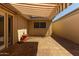 Outdoor patio with a retractable awning, tile flooring, and garden features at 8328 E Chaparral Rd, Scottsdale, AZ 85250