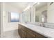 Bathroom with dual sinks, decorative lighting and separate bath tub at 8450 S Stephanie Ln, Tempe, AZ 85284