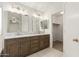 Bathroom with dual sinks, decorative lighting and walk-in closet at 8450 S Stephanie Ln, Tempe, AZ 85284