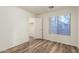 Bedroom with wood floors, a window, and a walk in closet at 8450 S Stephanie Ln, Tempe, AZ 85284
