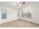 Bedroom with a ceiling fan, neutral carpet and view of outside at 8450 S Stephanie Ln, Tempe, AZ 85284