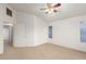 Bedroom featuring a ceiling fan, carpeting and a view of outside at 8450 S Stephanie Ln, Tempe, AZ 85284