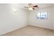 Bedroom with neutral carpet, lighted ceiling fan, and window for natural light at 8450 S Stephanie Ln, Tempe, AZ 85284