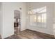 Dining room with wood-look floors, a modern chandelier, and a view of the kitchen at 8450 S Stephanie Ln, Tempe, AZ 85284