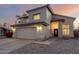 Desert home with stucco, two-car garage, and driveway, taken at sunset at 8450 S Stephanie Ln, Tempe, AZ 85284