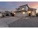 Desert home with stucco, two-car garage, and driveway, taken at sunset at 8450 S Stephanie Ln, Tempe, AZ 85284