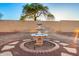 Beautiful outdoor fountain surrounded by gravel and stone accents, enhancing the backyard's serene atmosphere at 8450 S Stephanie Ln, Tempe, AZ 85284