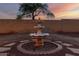 Close-up of a charming tiered fountain in the backyard, adding a touch of elegance to the outdoor space at 8450 S Stephanie Ln, Tempe, AZ 85284