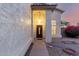 Front door under covered entrance way, shot at dusk, tan stucco at 8450 S Stephanie Ln, Tempe, AZ 85284