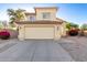 Two-story home with tan stucco, a two car garage and a driveway in the early morning at 8450 S Stephanie Ln, Tempe, AZ 85284