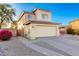 Two-story home with tan stucco, a two car garage and long driveway, shot in the early morning at 8450 S Stephanie Ln, Tempe, AZ 85284