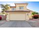 Two-story home with tan stucco, a two car garage and a driveway in the early morning at 8450 S Stephanie Ln, Tempe, AZ 85284