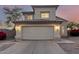 Two-story home with tan stucco, a two car garage and a driveway under an colorful evening sky at 8450 S Stephanie Ln, Tempe, AZ 85284