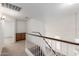 Upstairs hallway featuring wood-grain staircase and built-in cabinets at 8450 S Stephanie Ln, Tempe, AZ 85284