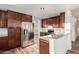 Modern kitchen with stainless steel appliances, granite counters, and wooden cabinetry at 8450 S Stephanie Ln, Tempe, AZ 85284