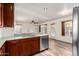 Kitchen with stainless steel dishwasher, granite counters, and wood floors at 8450 S Stephanie Ln, Tempe, AZ 85284