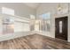 Bright living room featuring beautiful wood-look floors, high ceilings, and plantation shutters at 8450 S Stephanie Ln, Tempe, AZ 85284