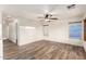 Bright, spacious living room featuring wood-look flooring, a ceiling fan, and bright lighting at 8450 S Stephanie Ln, Tempe, AZ 85284