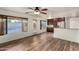 Bright living room and kitchen area with wood floors, large windows, and backyard access at 8450 S Stephanie Ln, Tempe, AZ 85284