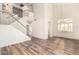 Open-concept living room showcasing soaring ceilings, wood-look floors, and a staircase at 8450 S Stephanie Ln, Tempe, AZ 85284