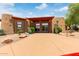 Clubhouse entrance features desert landscaping and a red canopy creating an inviting entrance to the community at 8500 E Southern Ave # 550, Mesa, AZ 85209