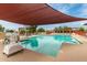 Community swimming pool with lounge chairs and sunshades, perfect for relaxation at 8500 E Southern Ave # 550, Mesa, AZ 85209