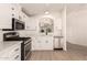 Kitchen featuring stainless appliances, white cabinets and counters, and a view to the living area at 8500 E Southern Ave # 550, Mesa, AZ 85209