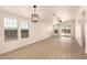 Spacious living room with large windows, modern light fixture, and sliding glass doors at 8500 E Southern Ave # 550, Mesa, AZ 85209