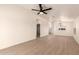 Open living area features wood-look floors, a ceiling fan, and an arched entry for added character at 8500 E Southern Ave # 550, Mesa, AZ 85209