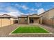 Spacious backyard offering low-maintenance gravel landscaping, a covered patio, and a patch of vibrant artificial grass at 9222 W Roma Ave, Phoenix, AZ 85037