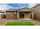 This backyard features a covered patio, easy-care gravel landscaping, and an inviting patch of green artificial turf at 9222 W Roma Ave, Phoenix, AZ 85037