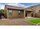 This backyard features low-maintenance landscaping, a covered patio, and a cozy artificial turf area at 9222 W Roma Ave, Phoenix, AZ 85037
