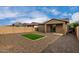 Wide angle view of the backyard with gravel, artificial grass, and a block wall at 9222 W Roma Ave, Phoenix, AZ 85037