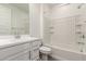 Clean bathroom features a white vanity, mirror, tiled shower, and white walls at 9222 W Roma Ave, Phoenix, AZ 85037